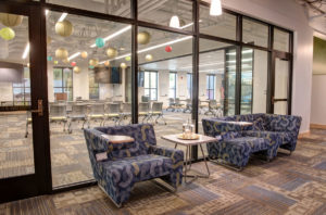 photo: common area with easy chairs and couch at the CMC Morgridge Commons
